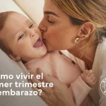 mamá dandole un beso a bebé durante el primer trimestre del embarazo